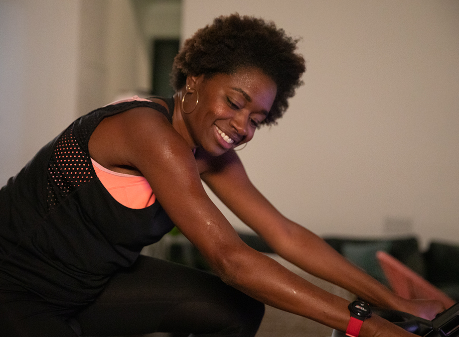 Smiling woman wearing a Myzone Switch heart rate monitor