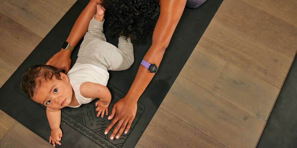 A young child on a yoga mat in a mum and baby yoga class