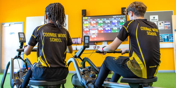Coombe Wood School students rowing in front of a Myzone screen
