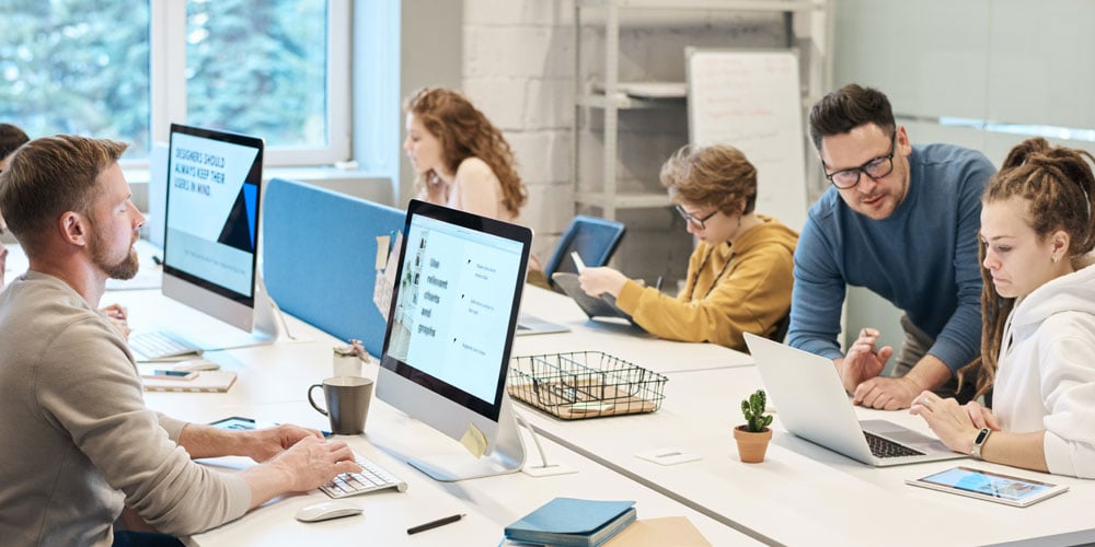 Busy office workspace with people working on computers