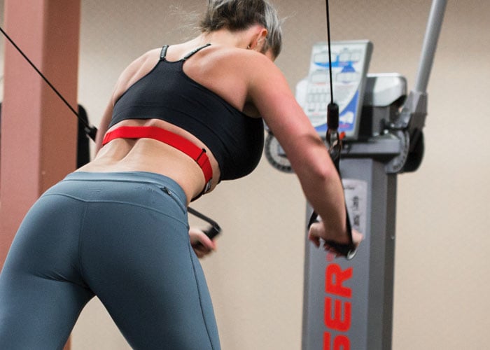 Woman using resistance machines