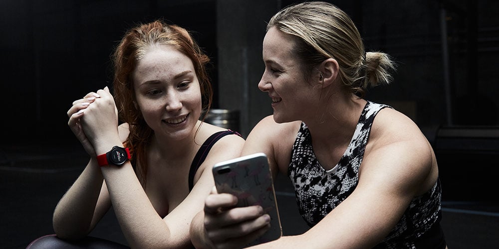 Two women looking at a smartphone