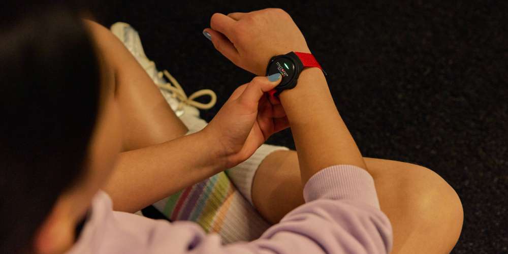A girl putting on the MZ-Switch heart rate monitor wrist strap