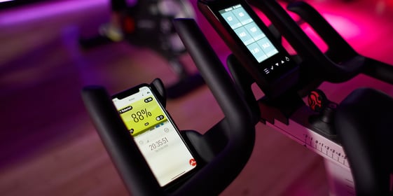 Phone with the Myzone app on an exercise bike