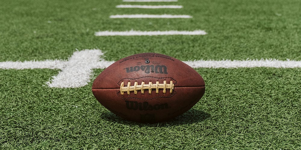 An American football on a sports field