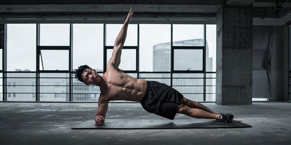 Man working on core strength in a side plank