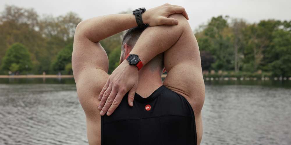 Man stretching wearing an MZ-Switch heart rate monitor on his arm