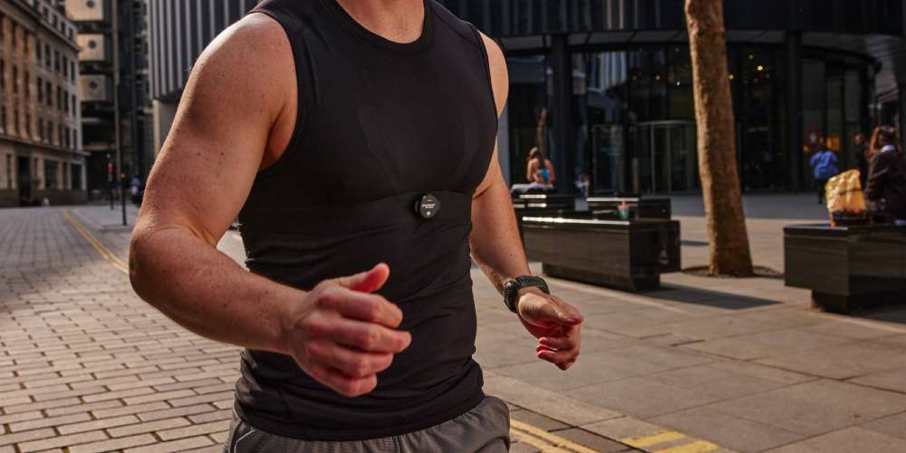 Man running through a city wearing an MZ-Switch heart rate monitor on his chest