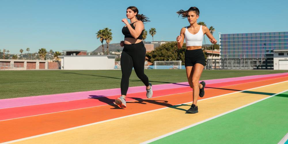 Two women exercising on a rainbow running track