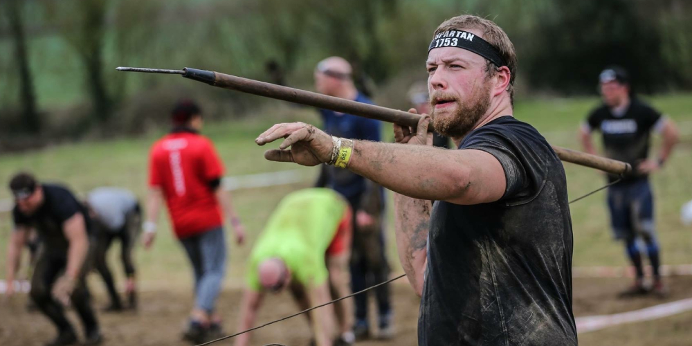 Man doing the spear throw at a Spartan race