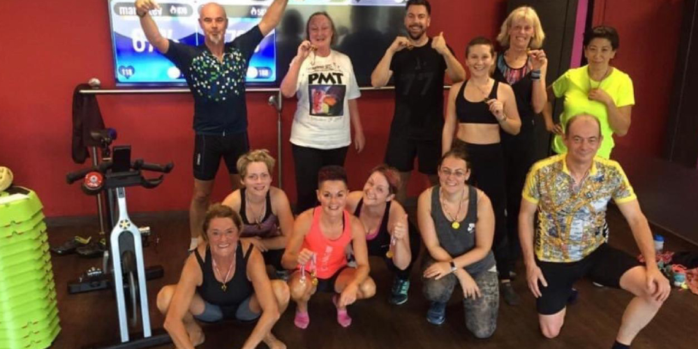 Group of gym members in front of a Myzone screen