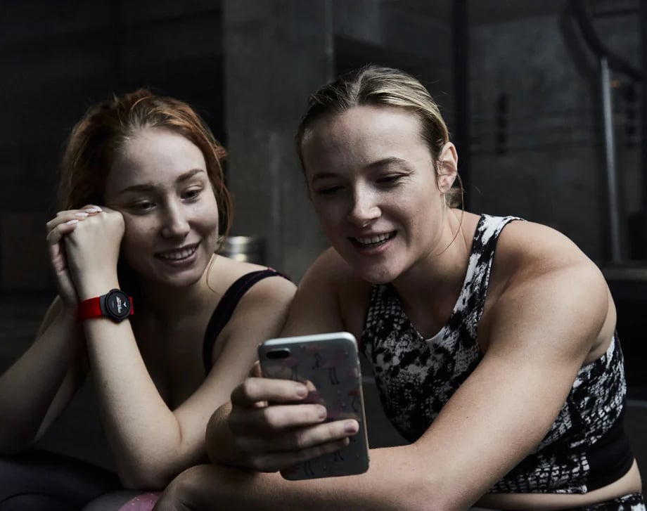 Women looking at the Myzone app on a smartphone