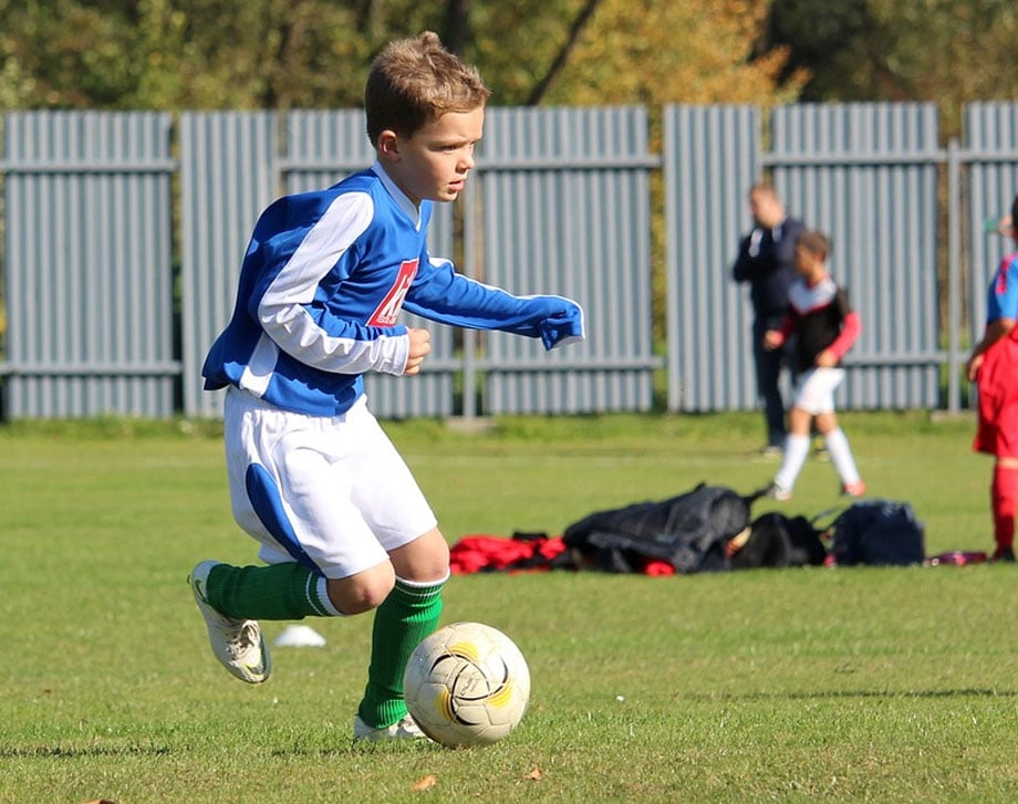 Boy playing football outside