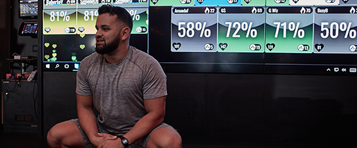 Personal trainer in front of a Myzone screen in the gym.