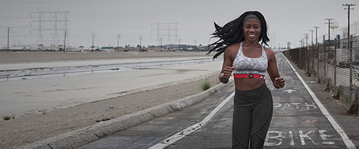 Woman running outside with a Myzone device