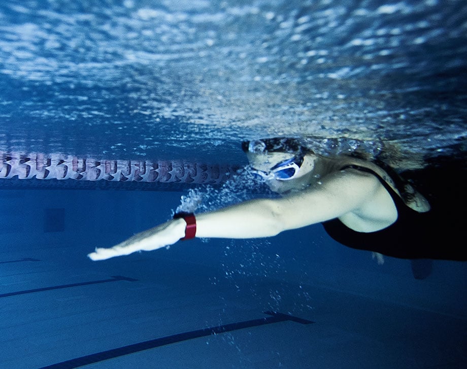 Swimmer underwater with a heart rate monitor