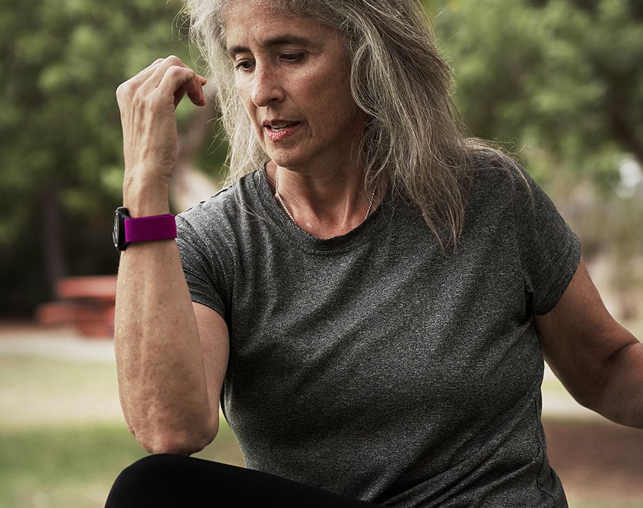 Woman exercising outdoors wearing a heart rate monitor