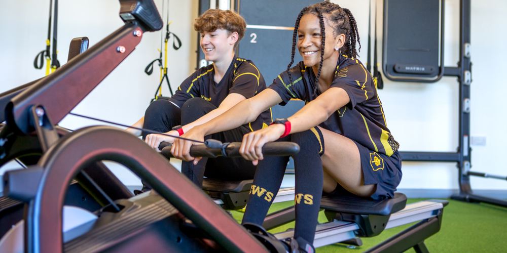 Two Coombe Wood School students rowing with Myzone Switch heart rate monitors