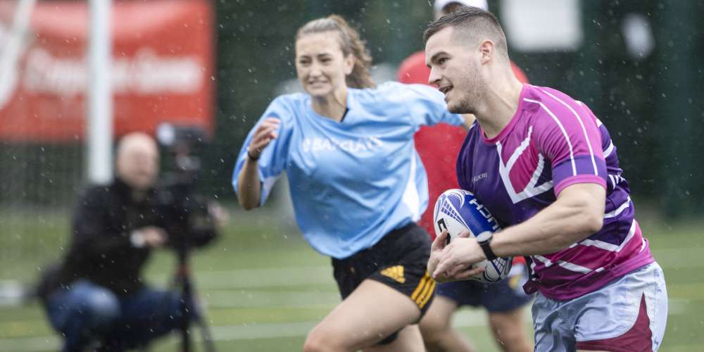 Two business employees playing rugby at the Corporate Games
