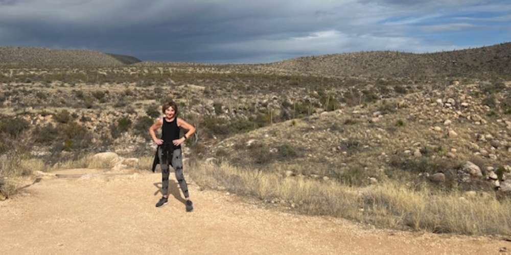 Older adult, Dianne Little, hiking in the countryside