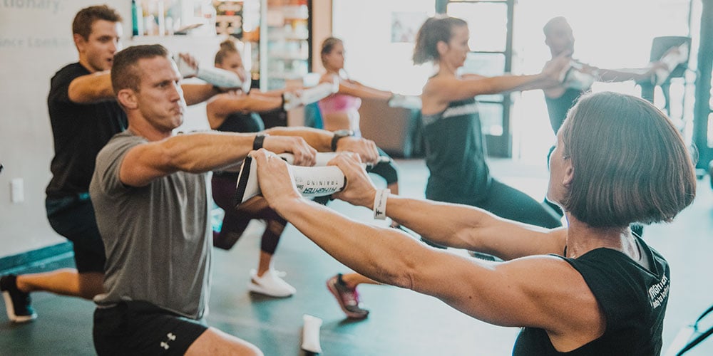 FitFighter class participants using the Steelhose in a workout