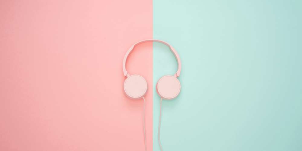 Headphones on a pastel pink and blue background