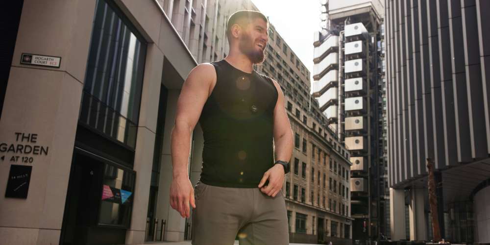 Man stood in a city wearing a heart rate monitor on his chest