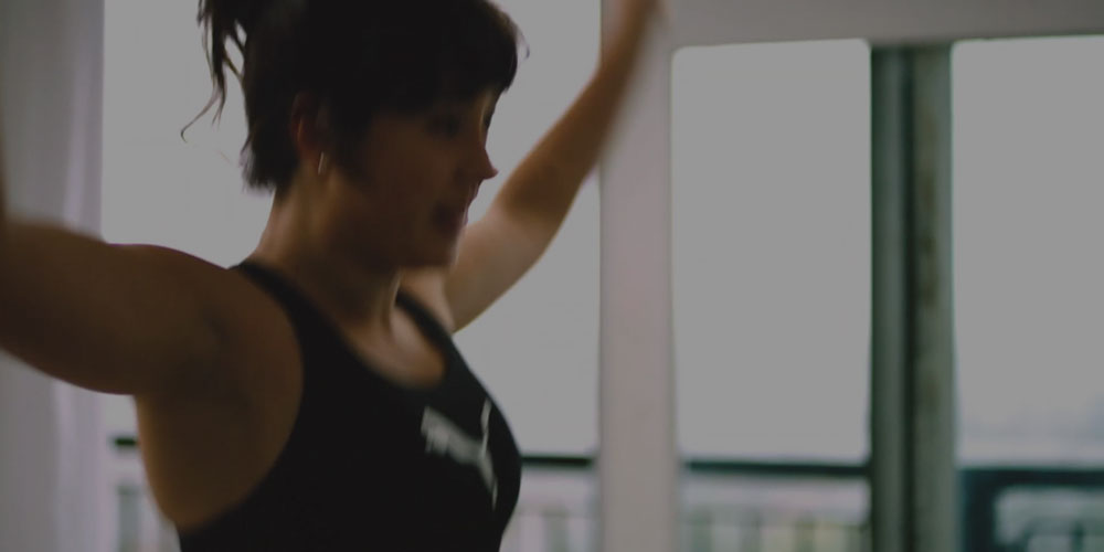 Woman exercising in a fitness class at home