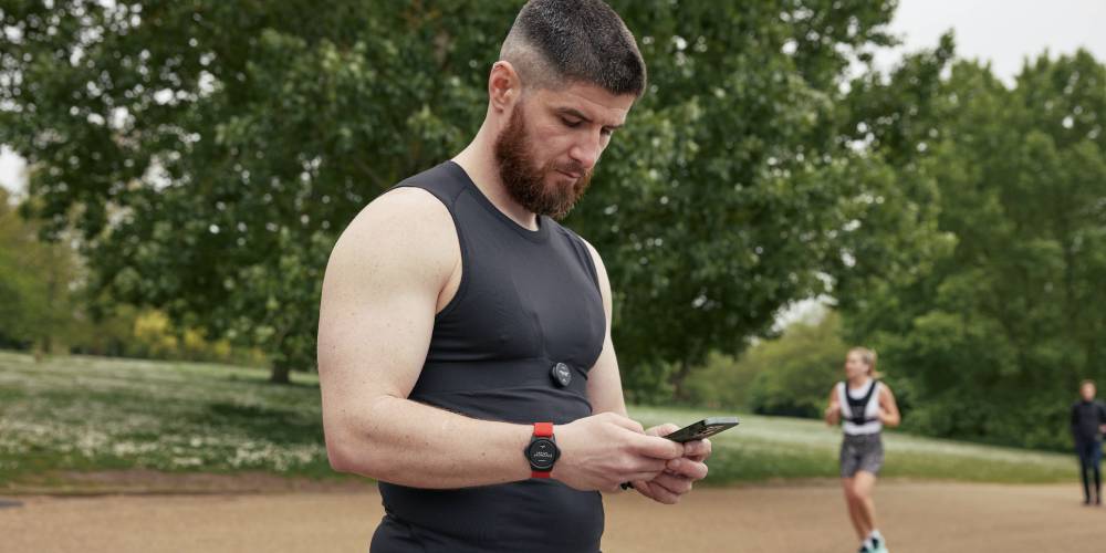 Man looking at the Myzone app in a park