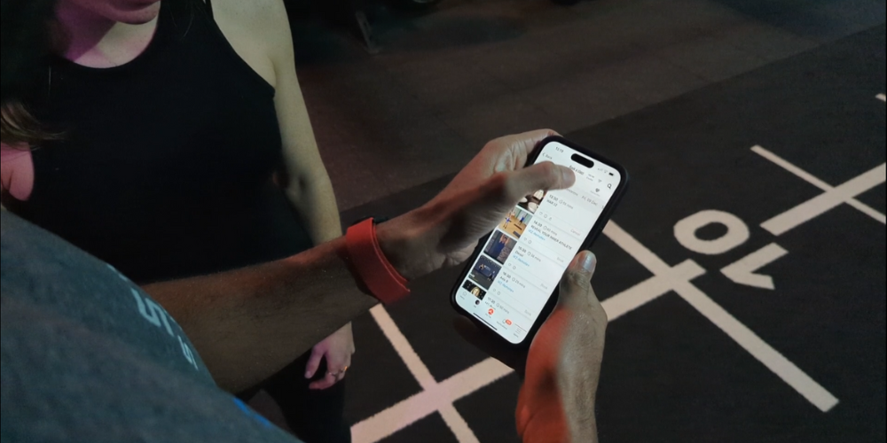 Someone in a gym using the Myzone app on their smartphone
