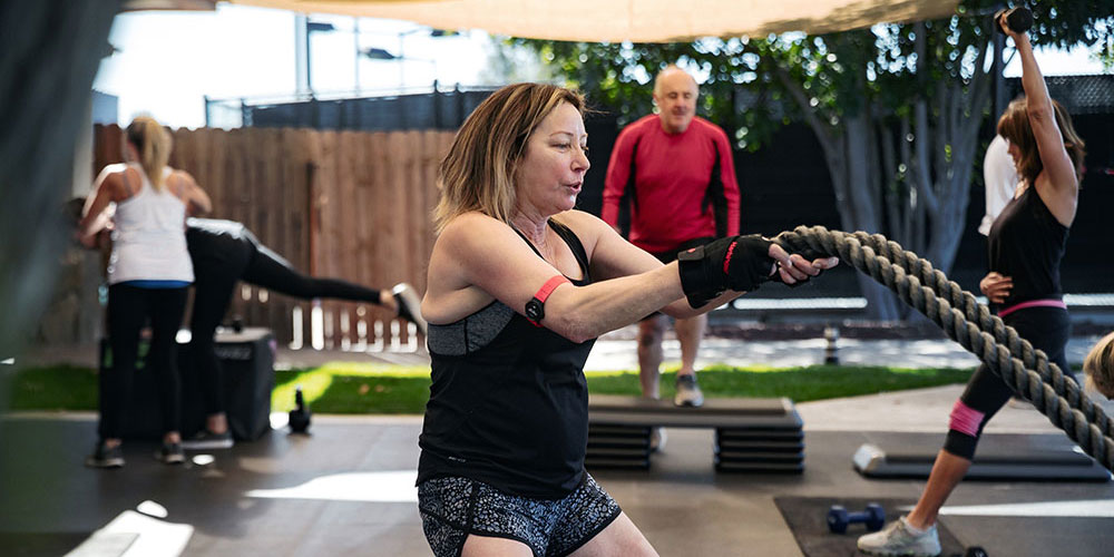 Group of people exercising outdoors in a gym environment