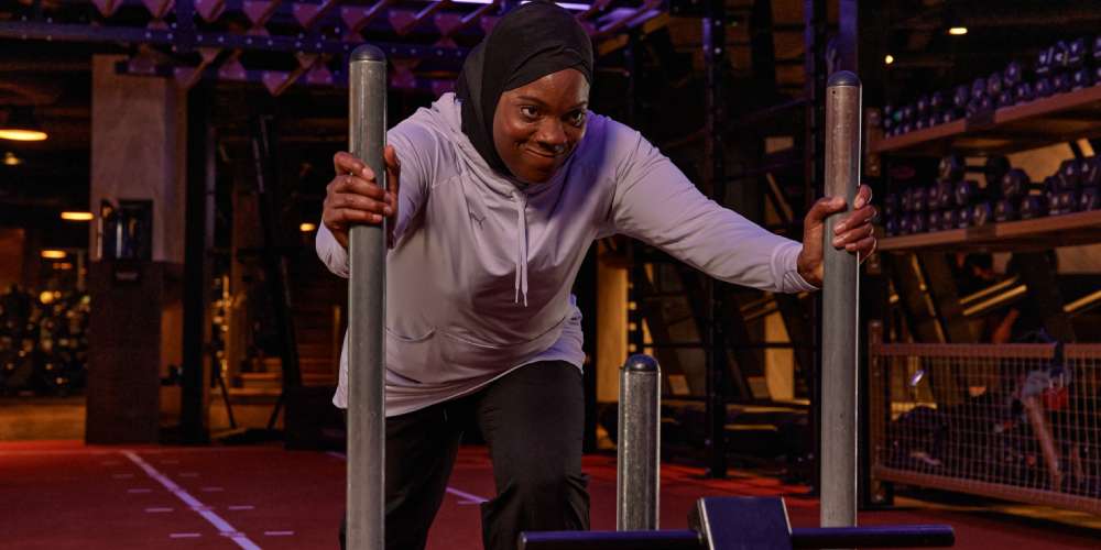Rugby player Zainab Alema pushing a sled in a gym